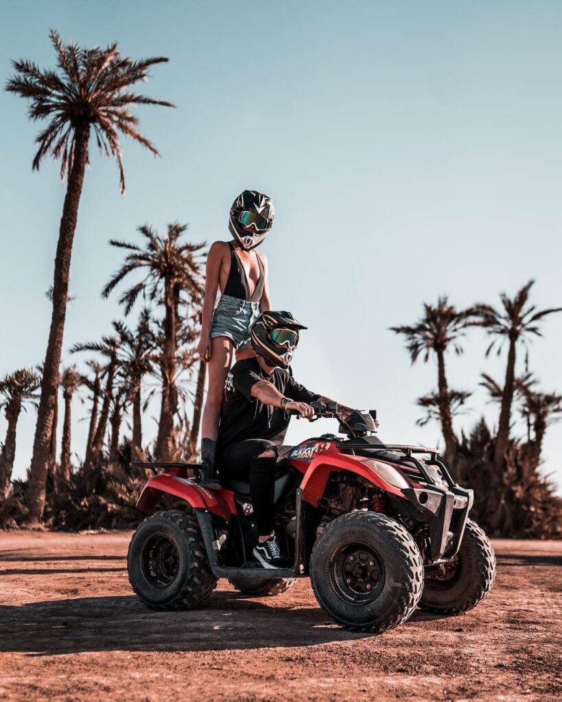 a couple having quad biking Marrakech experience in the palm grove