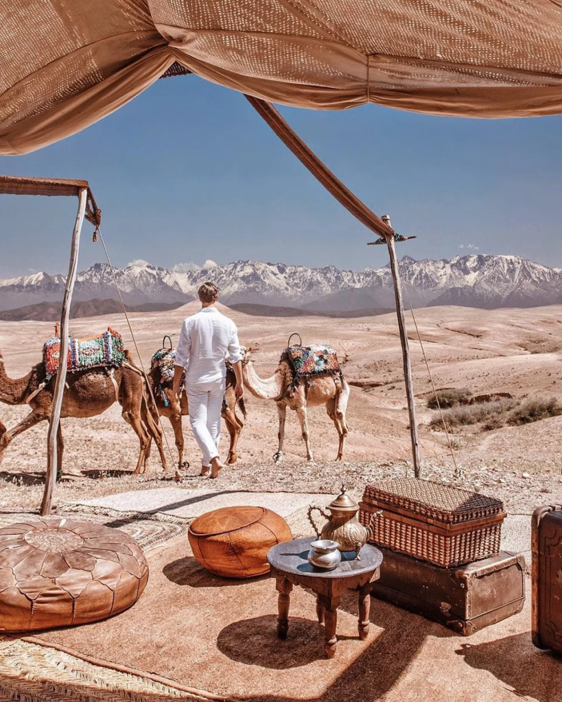 A man getting ready to have a camel ride in desert during his Agafay desert day trip from Marrakech